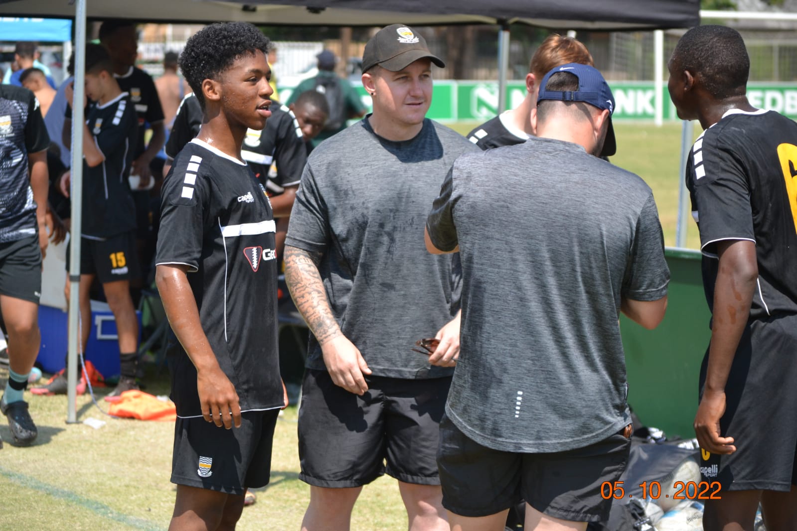Coach speaking with players during a match day